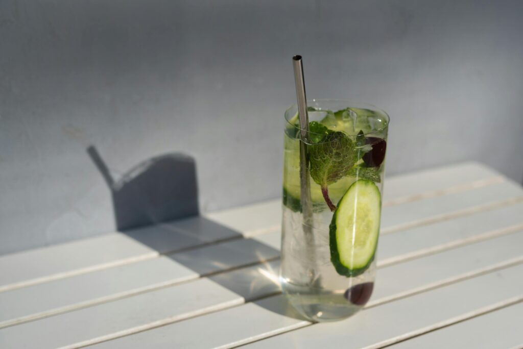 Chilled cucumber mint cocktail with a straw, perfect for a refreshing summer day.